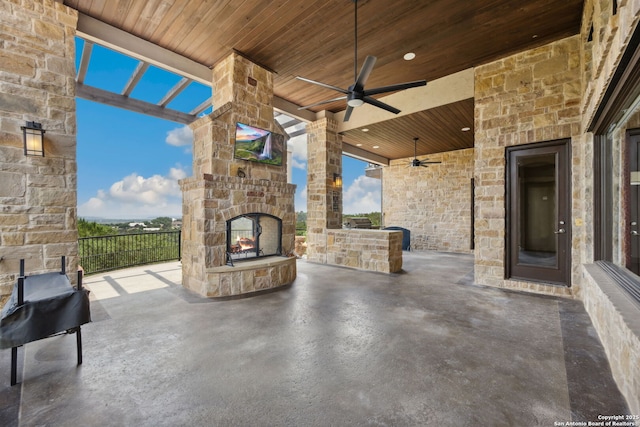 1078 Star Rdg, Spring Branch, TX 78070 - view of patio featuring an outdoor stone fireplace, ceiling fan, and exterior kitchen
