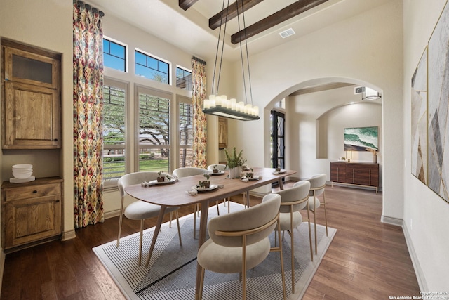 1078 Star Rdg, Spring Branch, TX 78070 - dining area with a high ceiling, arched walkways, dark wood finished floors, and baseboards