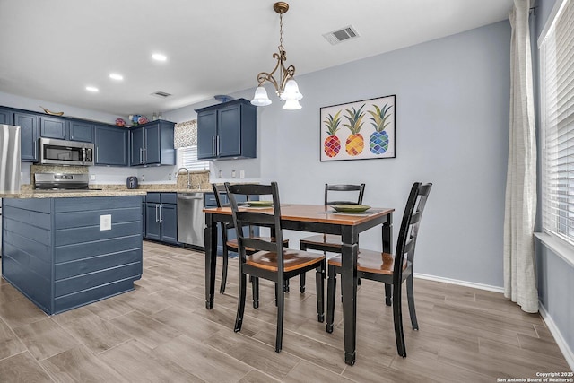 7715 Beechnut Oak, San Antonio, TX 78223 - dining area featuring light wood-style flooring, a chandelier, baseboards, and recessed lighting
