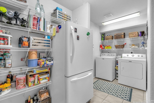 7715 Beechnut Oak, San Antonio, TX 78223 - laundry area featuring independent washer and dryer and tile patterned flooring