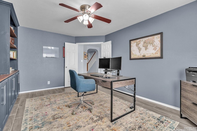 7715 Beechnut Oak, San Antonio, TX 78223 - office space with wood finish floors, ceiling fan, baseboards, and arched walkways