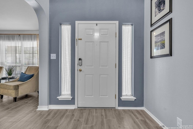 7715 Beechnut Oak, San Antonio, TX 78223 - foyer featuring arched walkways, baseboards, and wood finish floors