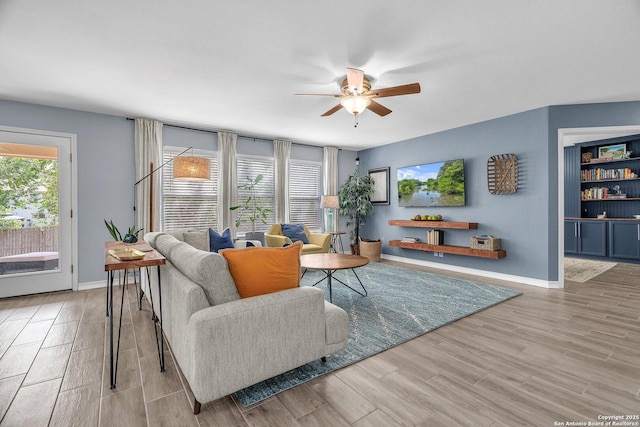 7715 Beechnut Oak, San Antonio, TX 78223 - living area with ceiling fan, wood finished floors, and baseboards