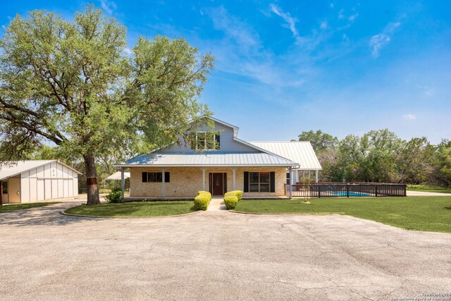 838 Georg Oaks, Bulverde, TX 78163 - view of front facade featuring metal roof, an outbuilding, a porch, and a detached garage