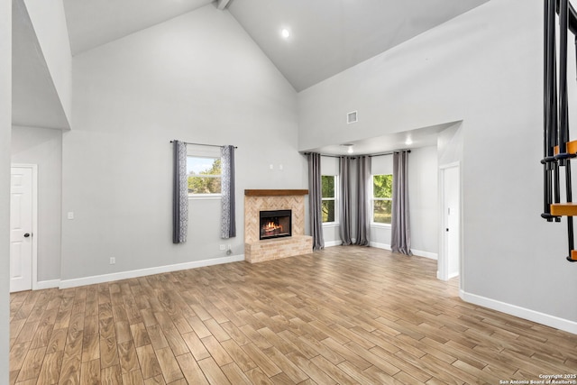 838 Georg Oaks, Bulverde, TX 78163 - unfurnished living room featuring high vaulted ceiling, light wood-style floors, plenty of natural light, and a brick fireplace