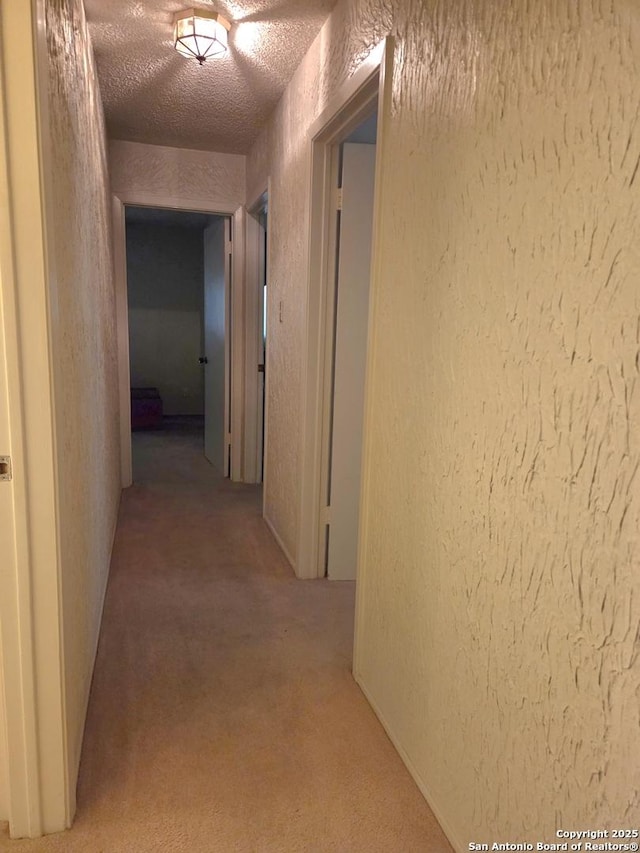 1319 Tideland, San Antonio, TX 78245 - hall featuring a textured wall, light colored carpet, and a textured ceiling