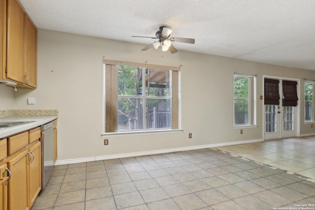 15527 Legend Spgs, San Antonio, TX 78247 - kitchen featuring healthy amount of natural light, ceiling fan, stainless steel dishwasher, a textured ceiling, and light tile patterned floors