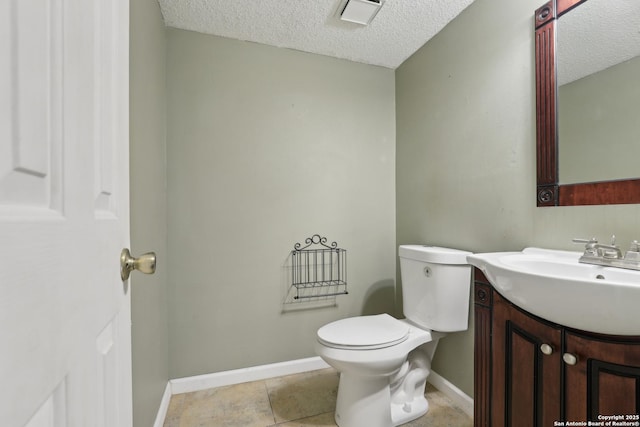 15527 Legend Spgs, San Antonio, TX 78247 - bathroom with a textured ceiling, vanity, toilet, baseboards, and tile patterned flooring