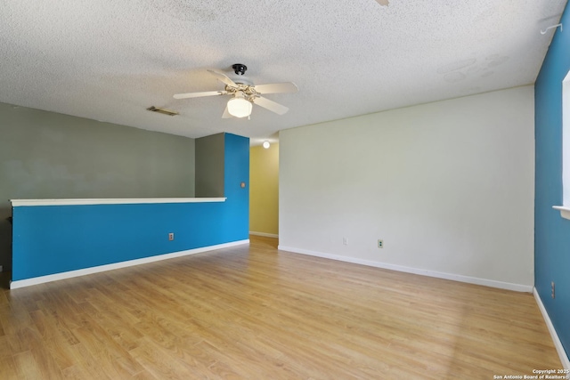 15527 Legend Spgs, San Antonio, TX 78247 - unfurnished room with ceiling fan, wood finished floors, a textured ceiling, and baseboards