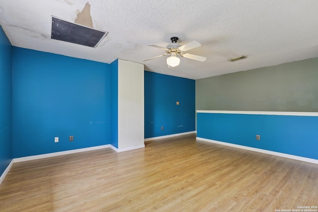 15527 Legend Spgs, San Antonio, TX 78247 - spare room with ceiling fan, wood finished floors, a textured ceiling, and baseboards