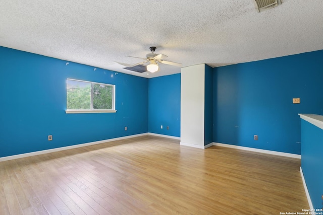 15527 Legend Spgs, San Antonio, TX 78247 - unfurnished room featuring ceiling fan, a textured ceiling, wood finished floors, and baseboards
