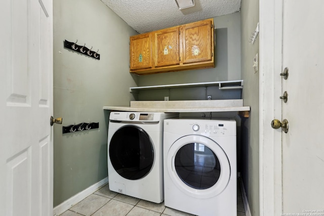 15527 Legend Spgs, San Antonio, TX 78247 - laundry area with cabinet space, washer and dryer, light tile patterned floors, a textured ceiling, and baseboards