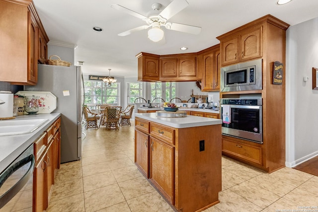 1434 Whispering Water, Spring Branch, TX 78070 - kitchen featuring appliances with stainless steel finishes, brown cabinets, light countertops, recessed lighting, and ceiling fan