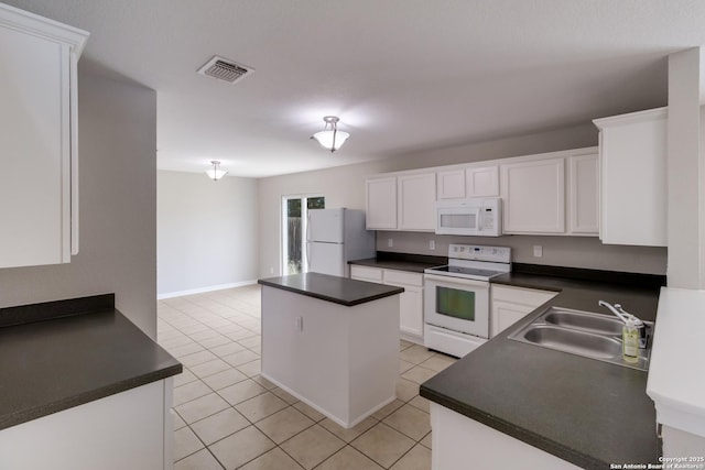 9618 Copper Fls, San Antonio, TX 78109 - kitchen featuring white appliances, a sink, dark countertops, and a kitchen island