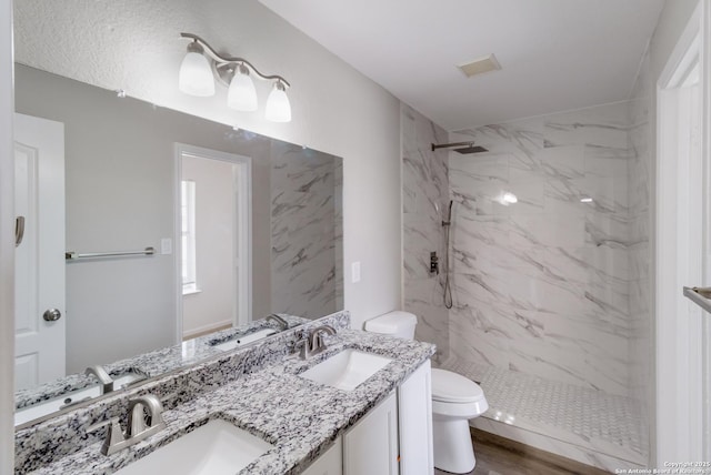 9618 Copper Fls, San Antonio, TX 78109 - bathroom with toilet, a marble finish shower, and double vanity