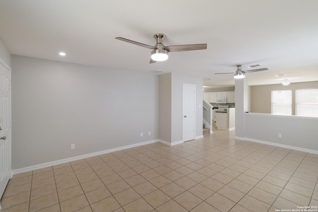 9618 Copper Fls, San Antonio, TX 78109 - unfurnished living room with a ceiling fan, recessed lighting, stairs, baseboards, and light tile patterned floors