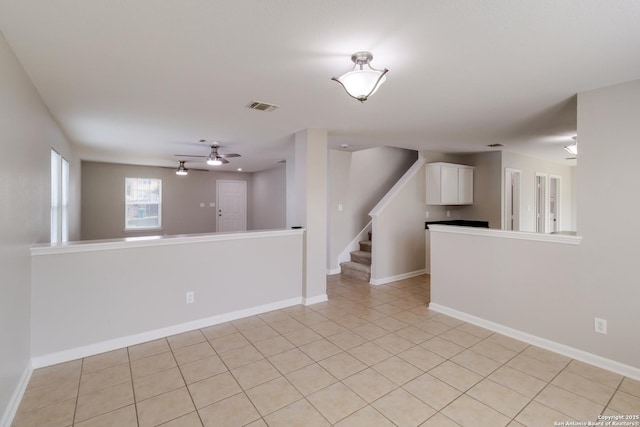 9618 Copper Fls, San Antonio, TX 78109 - spare room featuring stairway, light tile patterned floors, baseboards, and ceiling fan
