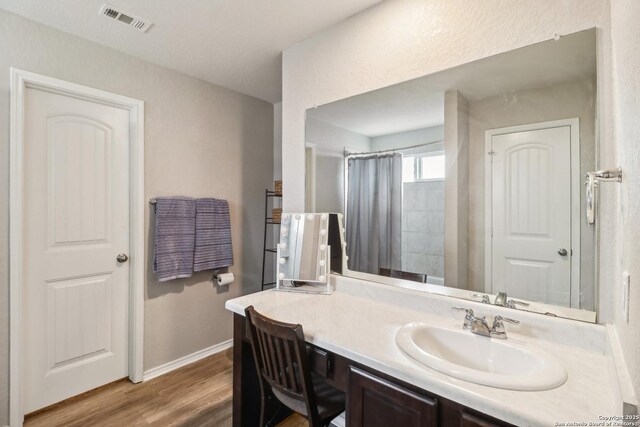 14721 Hooded Merganser, San Antonio, TX 78253 - full bathroom with baseboards, wood finished floors, vanity, and a shower with shower curtain