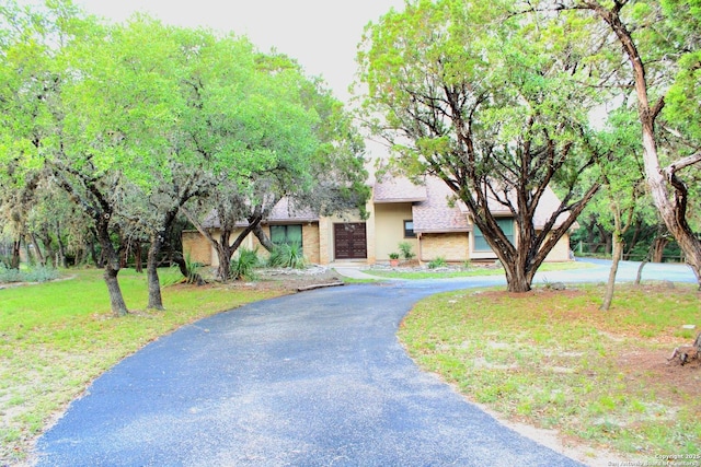 9118 Fox Briar, Boerne, TX 78006 - view of front of home with curved driveway, a front lawn, and stucco siding