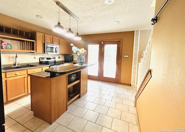 9208 Bowen, San Antonio, TX 78250 - kitchen featuring appliances with stainless steel finishes, open shelves, dark countertops, tasteful backsplash, and a sink