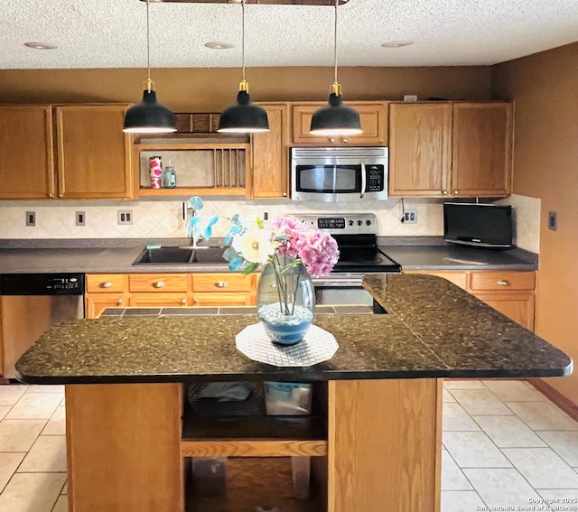 9208 Bowen, San Antonio, TX 78250 - kitchen with appliances with stainless steel finishes, light tile patterned floors, backsplash, a center island, and a textured ceiling