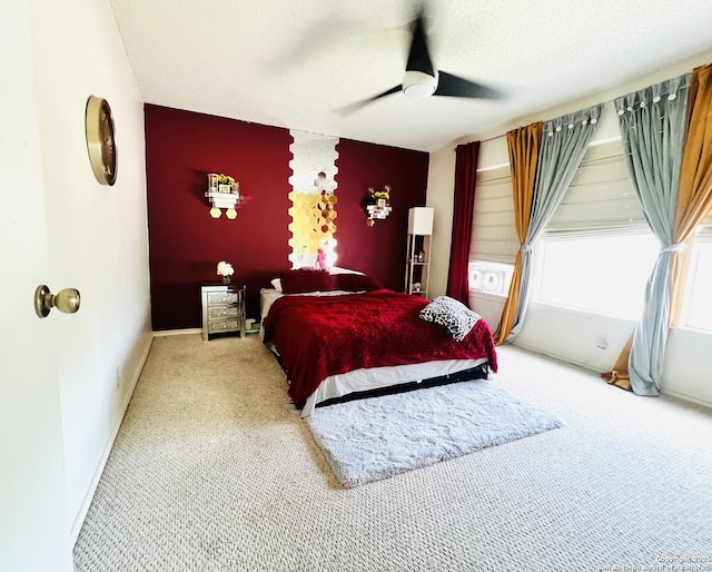 9208 Bowen, San Antonio, TX 78250 - bedroom featuring carpet flooring, an accent wall, a textured ceiling, baseboards, and a ceiling fan