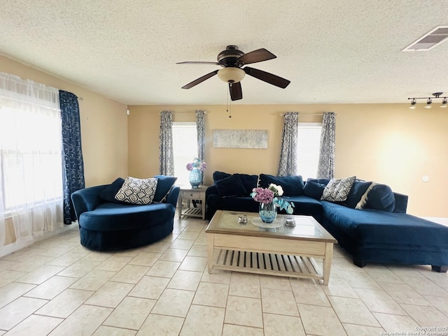 9208 Bowen, San Antonio, TX 78250 - living room featuring a ceiling fan, light tile patterned floors, a textured ceiling, and rail lighting