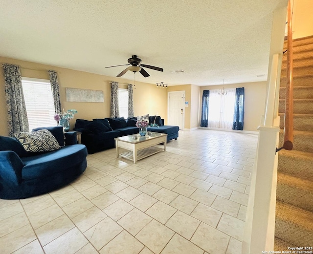9208 Bowen, San Antonio, TX 78250 - living area featuring light tile patterned floors, stairway, ceiling fan, a textured ceiling, and a chandelier