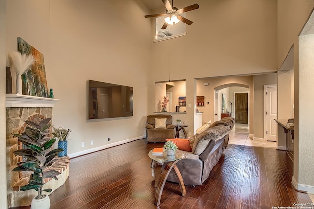 3811 Mira Mesa, San Antonio, TX 78259 - living area featuring arched walkways, a towering ceiling, ceiling fan, wood finished floors, and baseboards