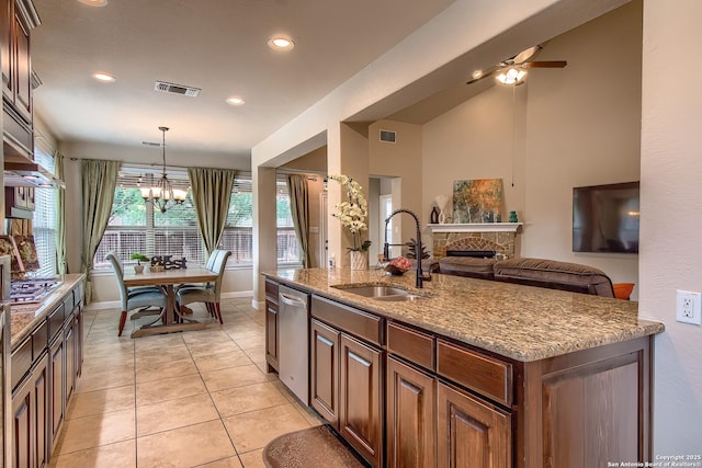 3811 Mira Mesa, San Antonio, TX 78259 - kitchen featuring a sink, a fireplace, ceiling fan, light stone countertops, and light tile patterned flooring