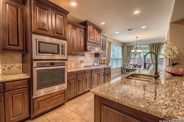 3811 Mira Mesa, San Antonio, TX 78259 - kitchen featuring stainless steel appliances, a sink, recessed lighting, decorative backsplash, and light stone countertops