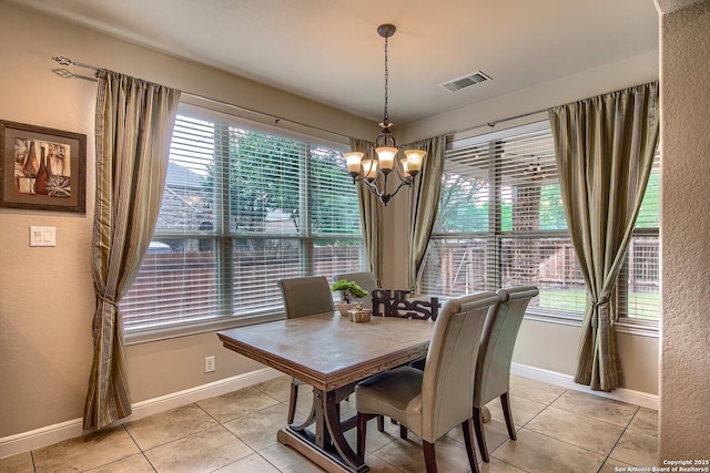3811 Mira Mesa, San Antonio, TX 78259 - dining area with a chandelier, light tile patterned floors, baseboards, and a textured wall