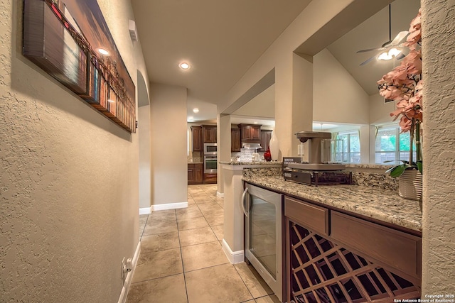 3811 Mira Mesa, San Antonio, TX 78259 - kitchen with light tile patterned flooring, appliances with stainless steel finishes, wine cooler, light stone countertops, and ceiling fan
