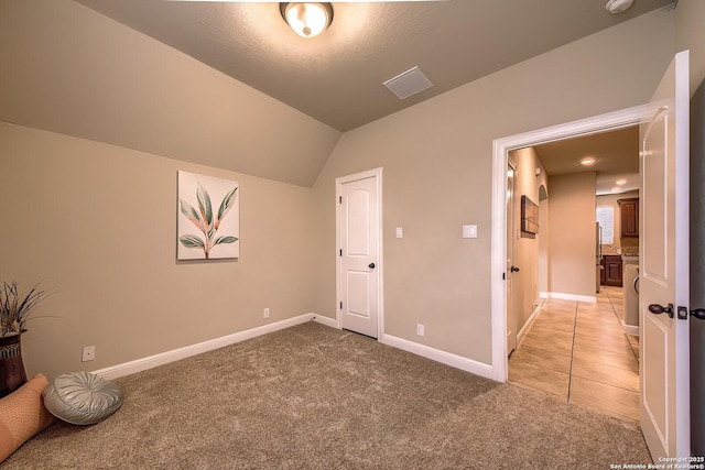 3811 Mira Mesa, San Antonio, TX 78259 - unfurnished bedroom featuring light colored carpet, vaulted ceiling, and baseboards