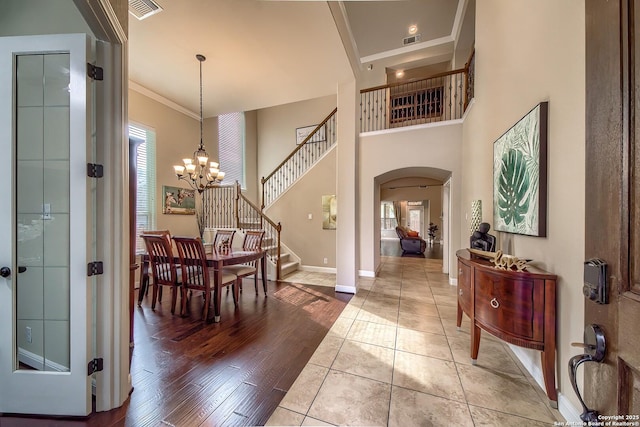 3811 Mira Mesa, San Antonio, TX 78259 - entrance foyer featuring arched walkways, ornamental molding, a chandelier, baseboards, and stairway