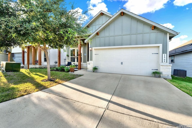 11706 Troubadour Trl, San Antonio, TX 78245 - view of front of home with board and batten siding, a front yard, central AC unit, and driveway