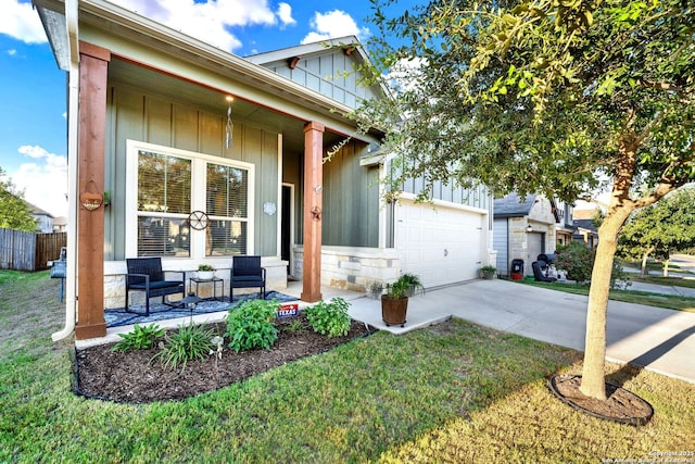 11706 Troubadour Trl, San Antonio, TX 78245 - view of front facade with concrete driveway, board and batten siding, a garage, covered porch, and a front lawn