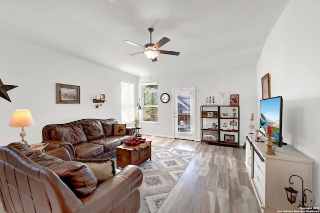 11706 Troubadour Trl, San Antonio, TX 78245 - living room with a ceiling fan, light wood finished floors, and baseboards