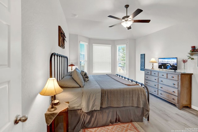 11706 Troubadour Trl, San Antonio, TX 78245 - bedroom featuring light wood-style flooring, a ceiling fan, and baseboards