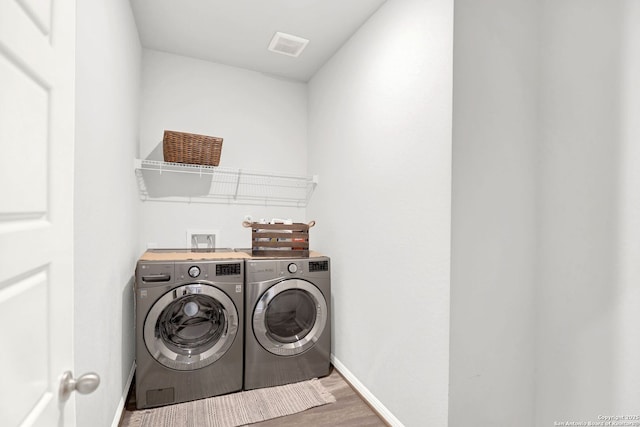 11706 Troubadour Trl, San Antonio, TX 78245 - washroom with independent washer and dryer, wood finished floors, and baseboards