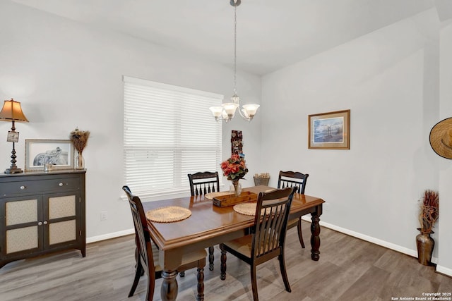 11706 Troubadour Trl, San Antonio, TX 78245 - dining space with a chandelier, wood finished floors, and baseboards