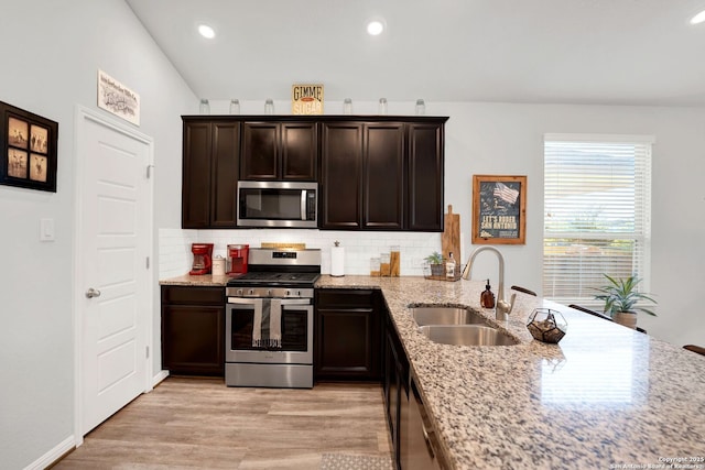 11706 Troubadour Trl, San Antonio, TX 78245 - kitchen featuring stainless steel appliances, a sink, backsplash, light stone countertops, and recessed lighting