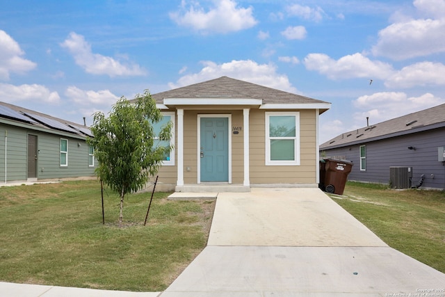 14418 Southton Basin, San Antonio, TX 78223 - view of front facade with cooling unit, a front yard, and concrete driveway