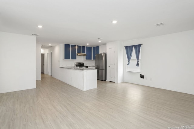 14418 Southton Basin, San Antonio, TX 78223 - kitchen with stainless steel appliances, a peninsula, recessed lighting, light countertops, and light wood-type flooring