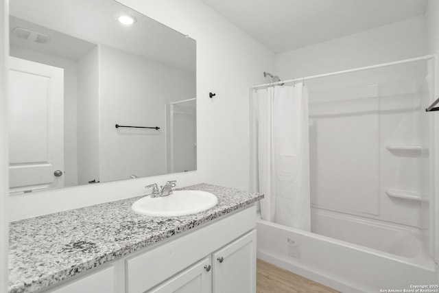14418 Southton Basin, San Antonio, TX 78223 - full bathroom featuring shower / tub combo with curtain, vanity, and wood finished floors