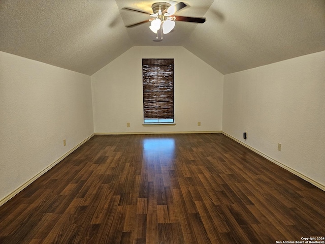 3524 Angora Trl, Schertz, TX 78154 - additional living space with a ceiling fan, dark wood-style floors, vaulted ceiling, baseboards, and a textured ceiling