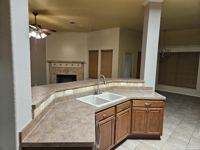 3524 Angora Trl, Schertz, TX 78154 - kitchen with a sink, open floor plan, light tile patterned floors, ceiling fan, and a tiled fireplace