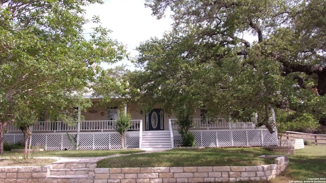 786 Stirrup, Spring Branch, TX 78070 - obstructed view of property with covered porch and a front lawn