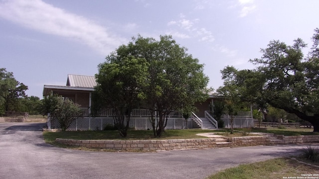 786 Stirrup, Spring Branch, TX 78070 - obstructed view of property with a porch and stairway