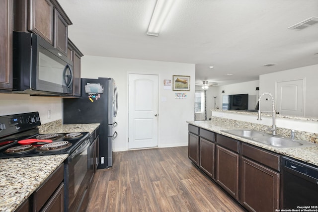 6631 Rosenthal Pass, San Antonio, TX 78252 - kitchen featuring black appliances, a sink, dark brown cabinetry, dark wood-type flooring, and light stone countertops